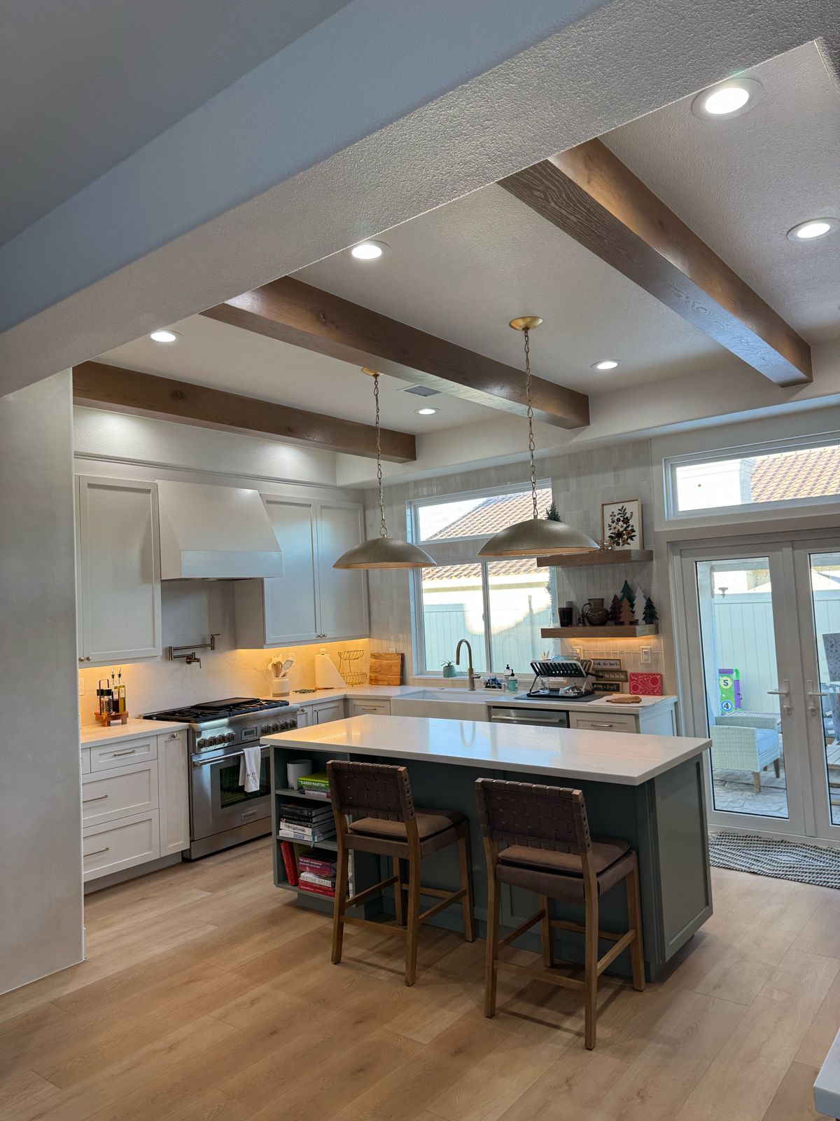 Kitchen remodel with wood beams and green island