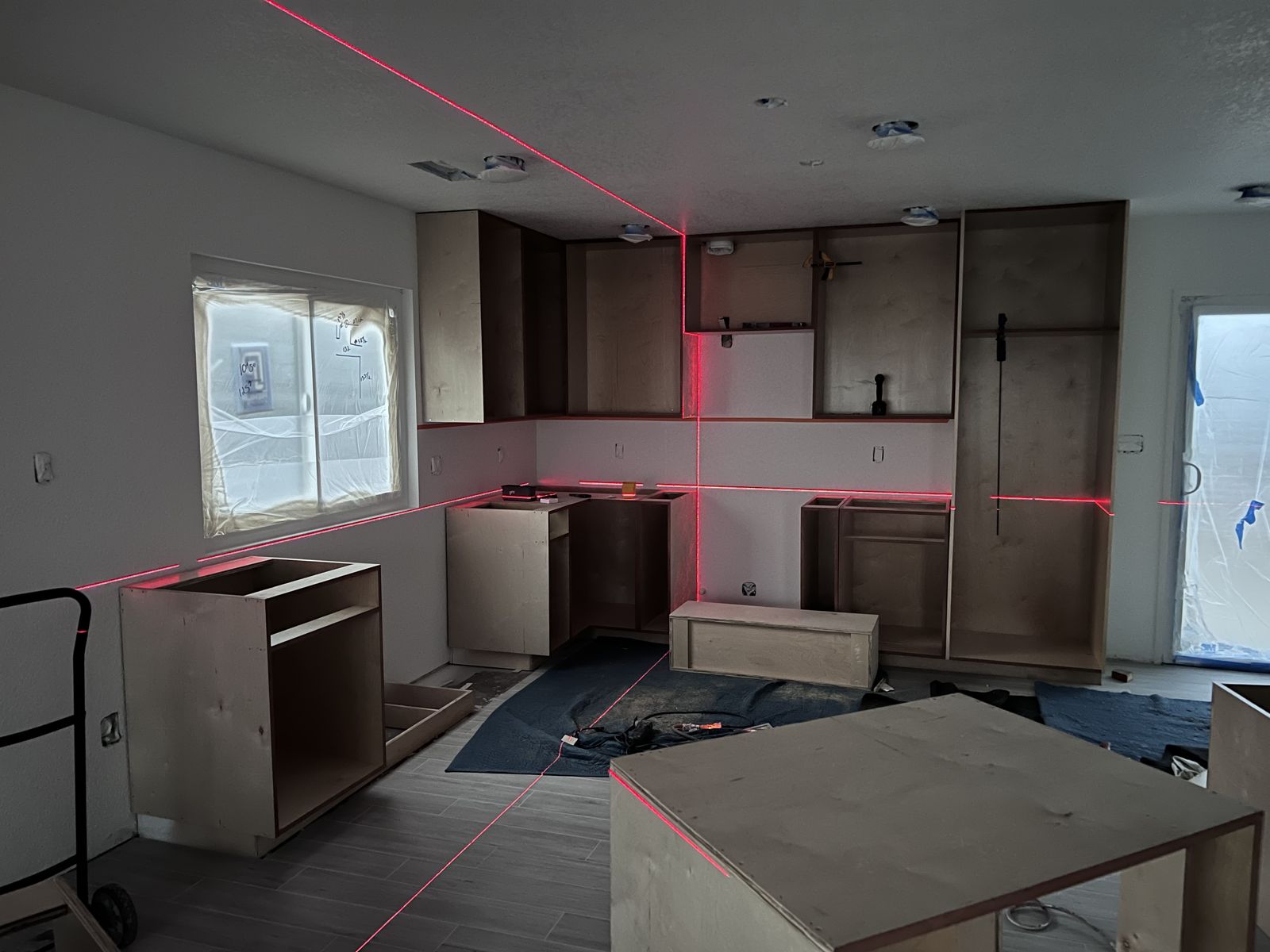 Laser level aligning cabinets